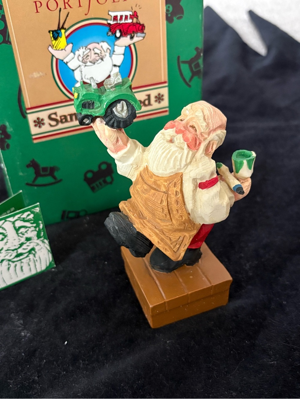 Santa Claus Figurine Holding Green Tractor